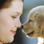 Woman Rubbing Noses with Puppy
